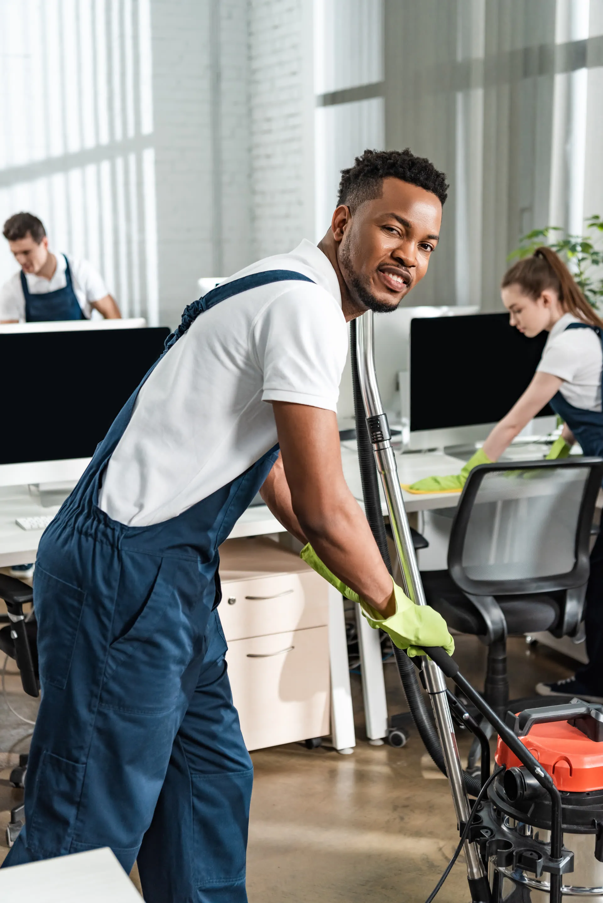 Glō team member cleaning around office workstations