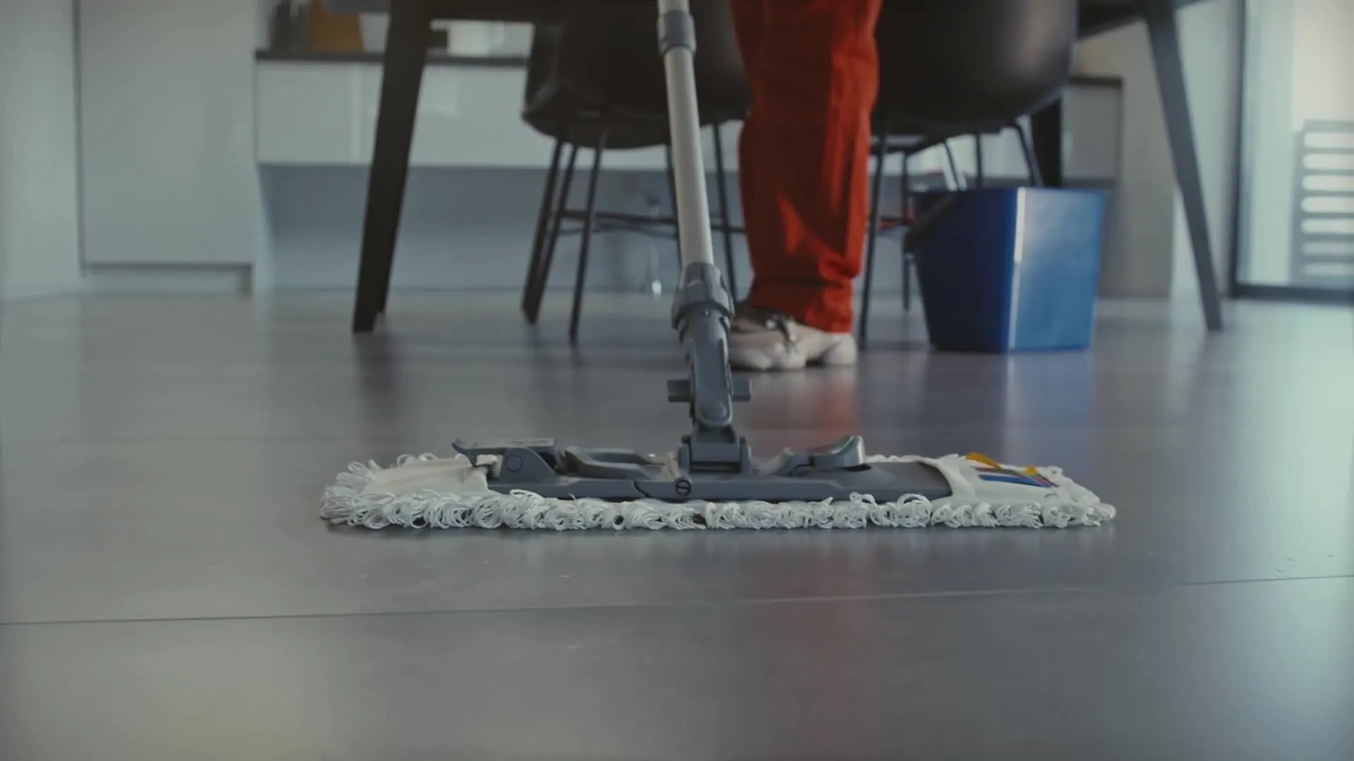 Close-up of a flat mop cleaning a polished floor